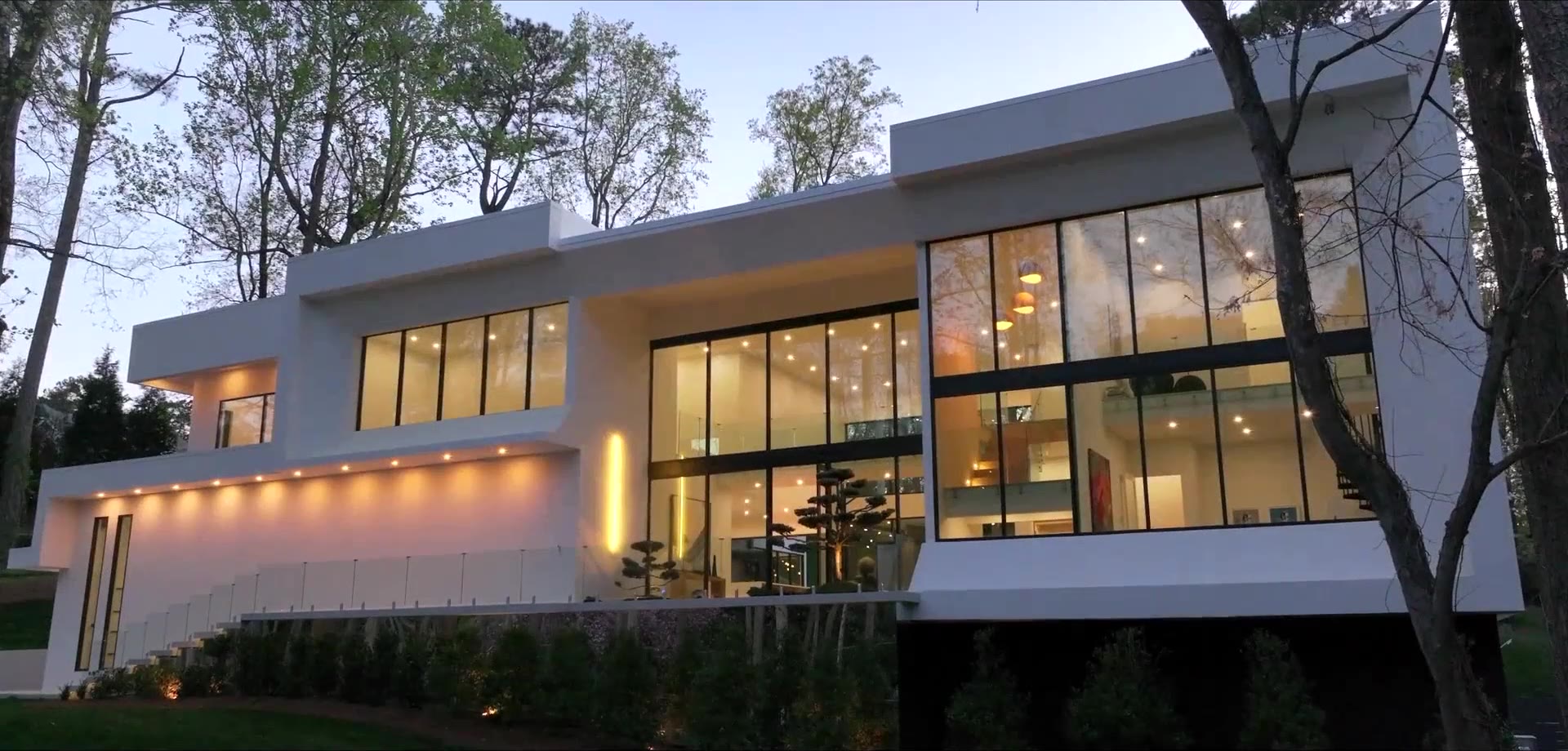 A bright, modern luxury home interior with floor to ceiling windows